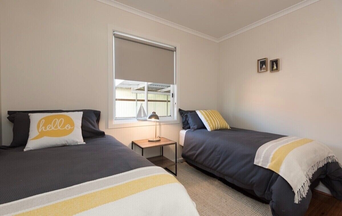 Twin bedroom with yellow accents
