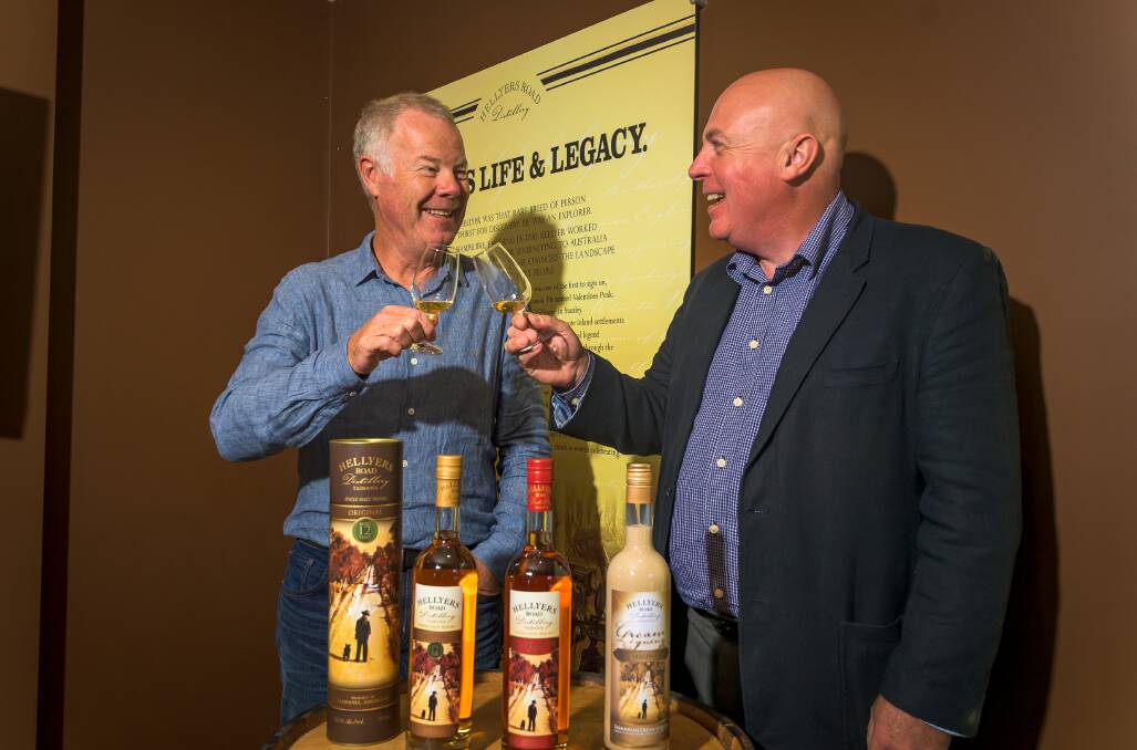 Two men toasting with Hellyers Road Tasmanian single malt whisky at the distillery